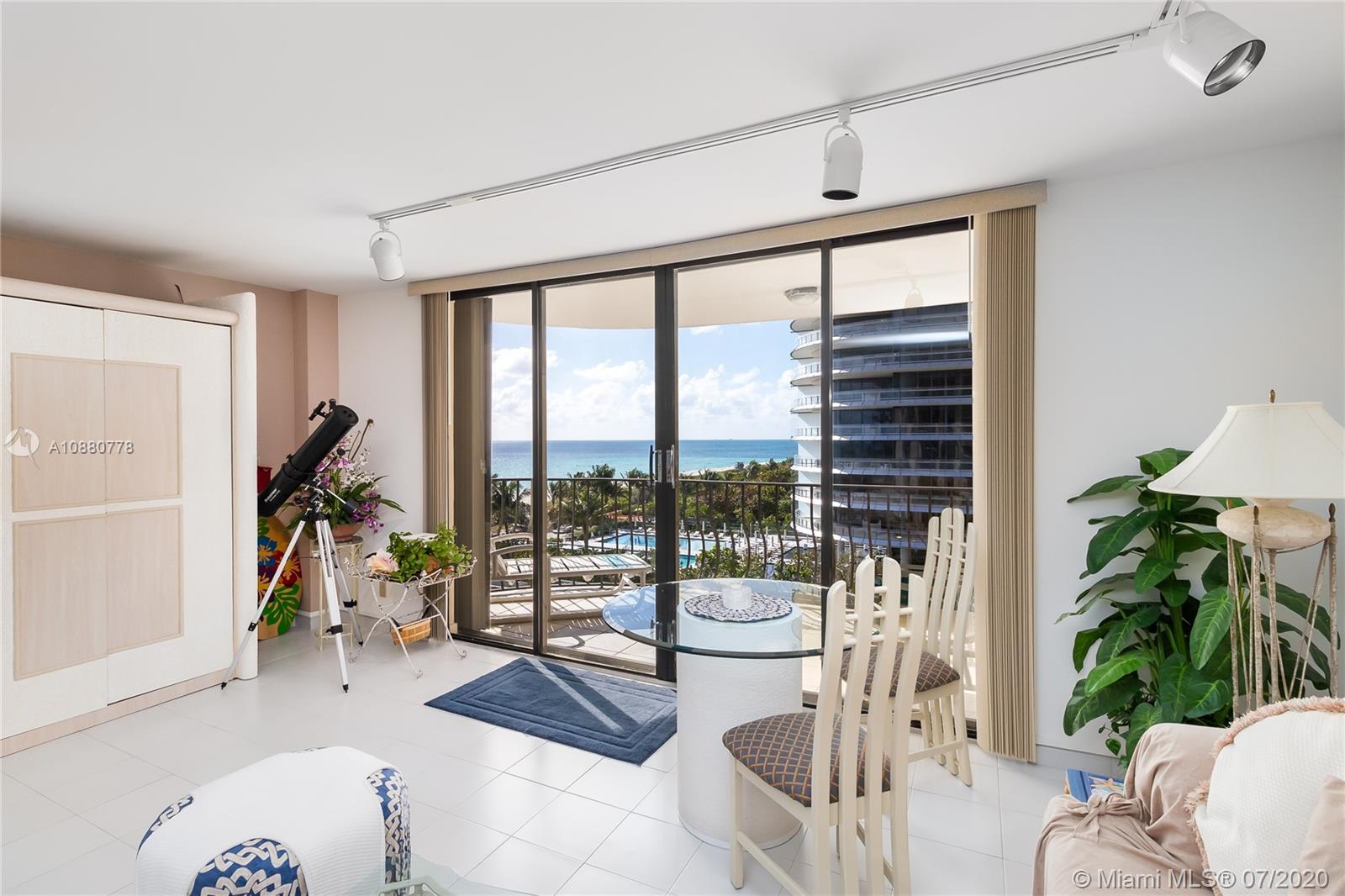 8777 Collins Avenue, Unit 611 Surfside, FL 33154 - Photo 4 of 22 a living room filled with furniture and a potted plant