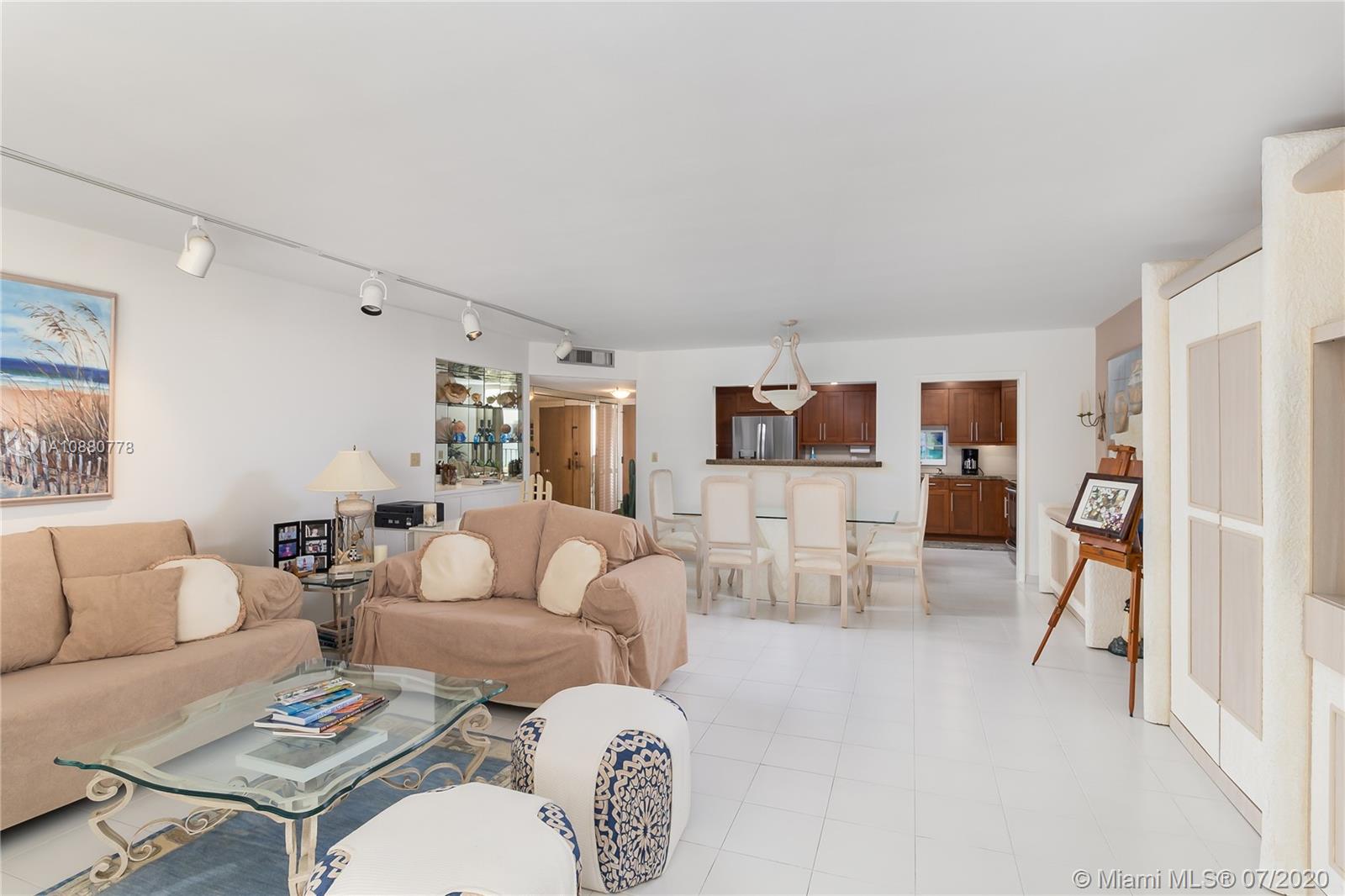 8777 Collins Avenue, Unit 611 Surfside, FL 33154 - Photo 6 of 22 a living room with furniture and a table