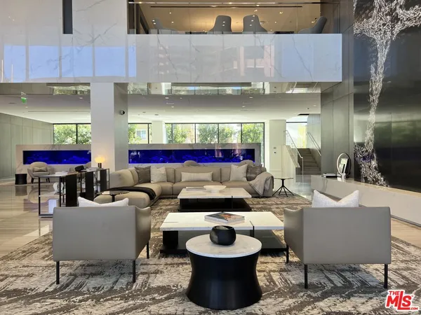 a living room with furniture and a floor to ceiling window