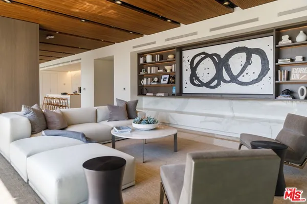 a living room with furniture and wall paintings