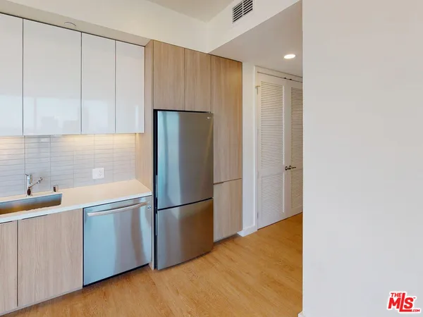 a kitchen with a refrigerator and a sink