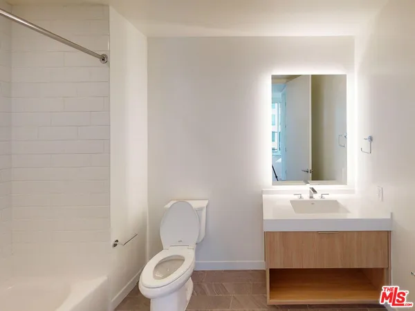 a bathroom with a sink toilet and mirror