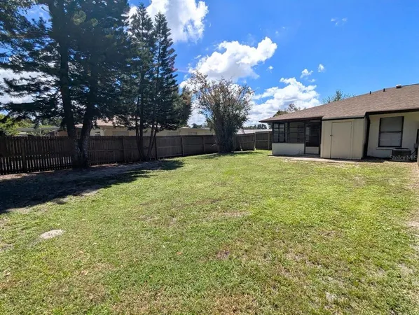 a view of a yard with a house in the background