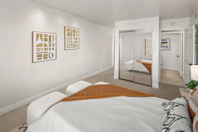 a bedroom with a bed and a painting on the wall