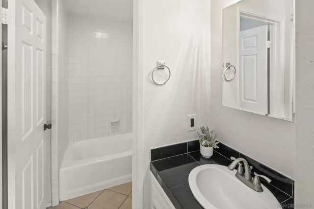 a bathroom with a sink a mirror and a bathtub