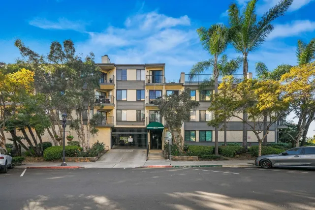 a city street lined with buildings and trees