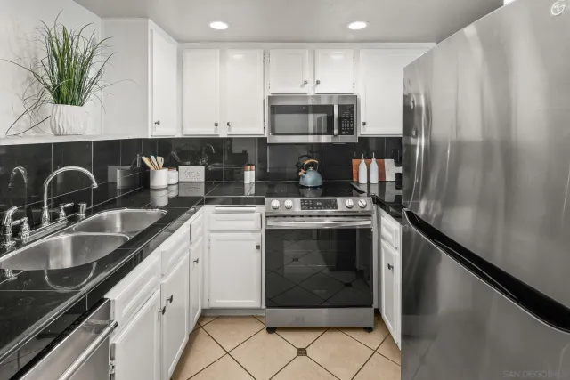 a kitchen with a sink appliances and cabinets