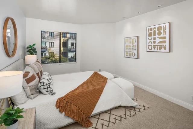 a bedroom with furniture and a window