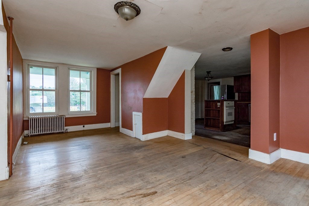 11 Ed Clark Road Hubbardston, MA 01452 - Photo 11 of 42 an empty room with wooden floor and windows