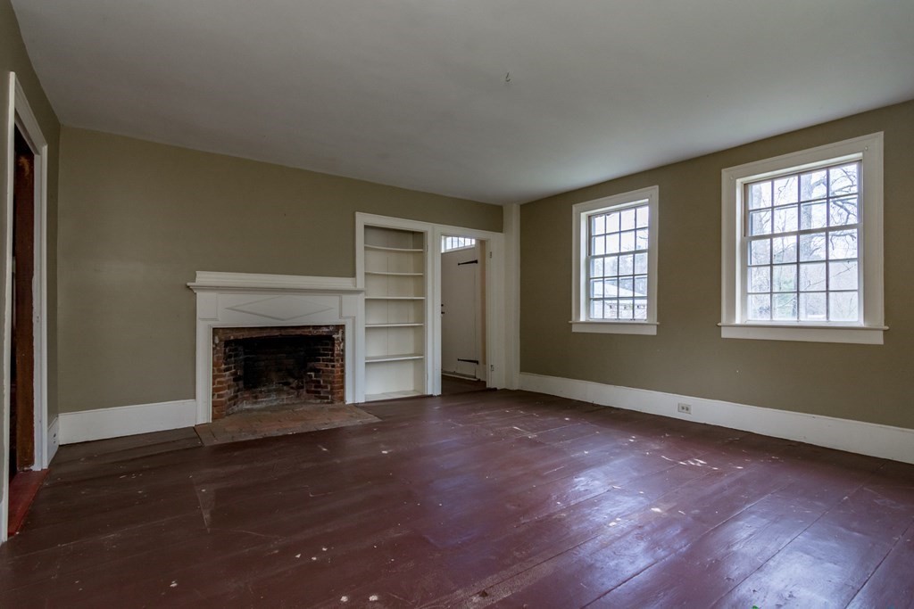 11 Ed Clark Road Hubbardston, MA 01452 - Photo 16 of 42 an empty room with windows and fireplace