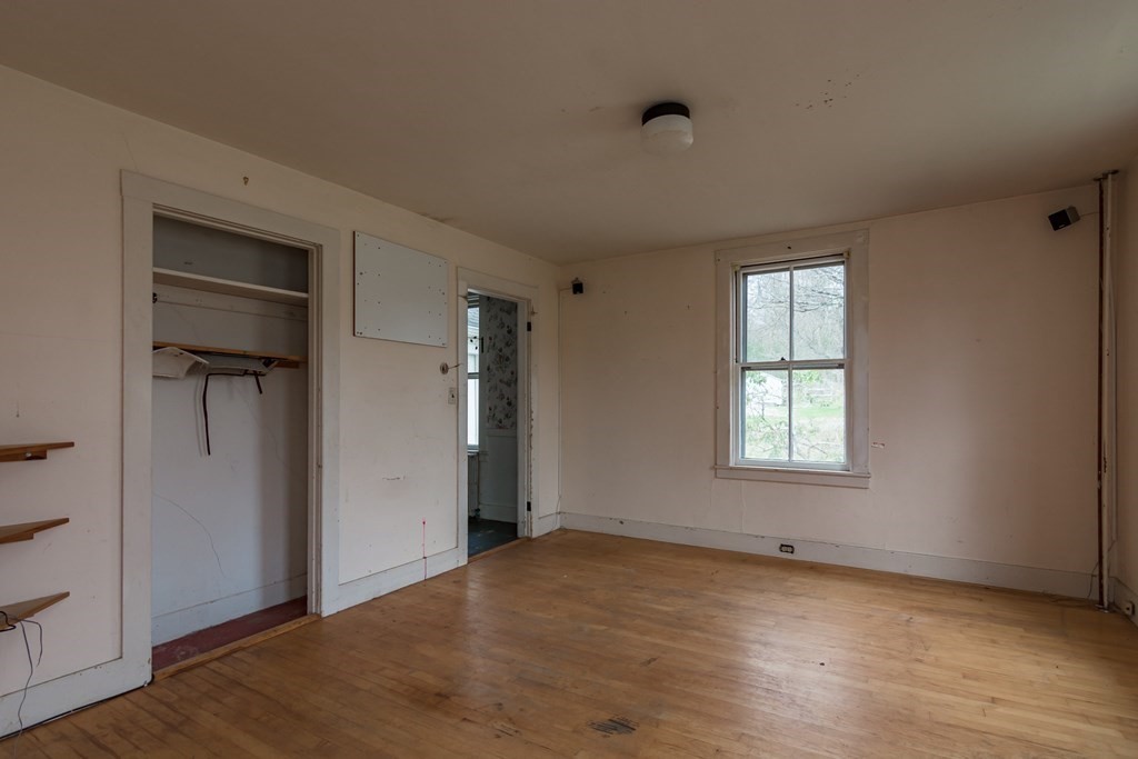 11 Ed Clark Road Hubbardston, MA 01452 - Photo 29 of 42 an empty room with wooden floor closet and windows