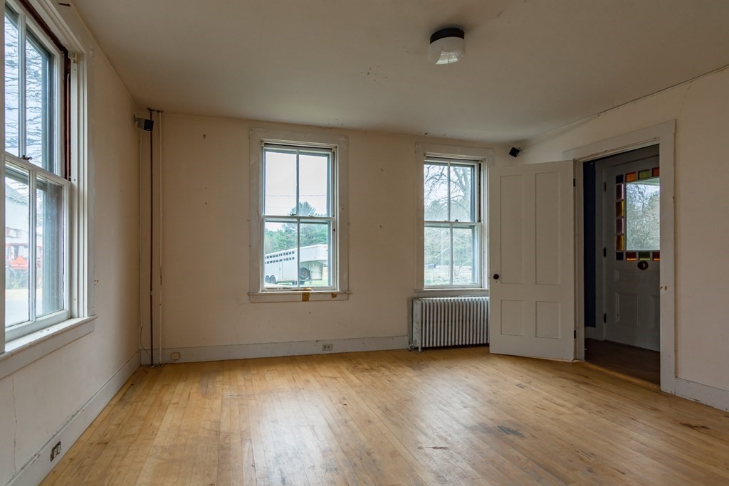 11 Ed Clark Road Hubbardston, MA 01452 - Photo 31 of 42 an empty room with wooden floor and windows