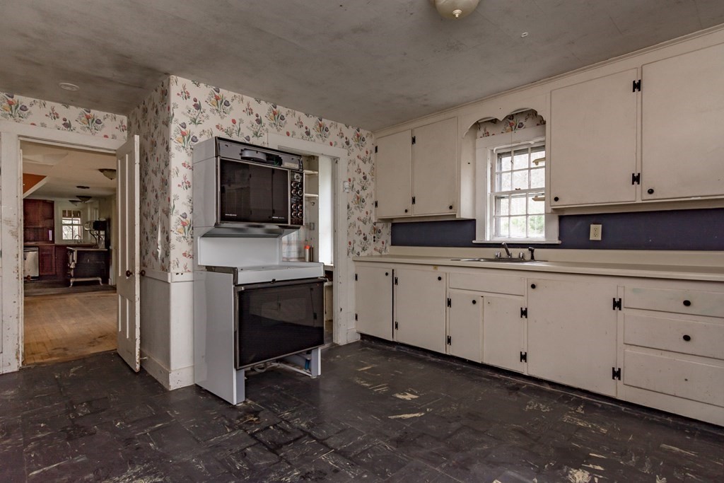 11 Ed Clark Road Hubbardston, MA 01452 - Photo 8 of 42 a kitchen with granite countertop white cabinets and stainless steel appliances
