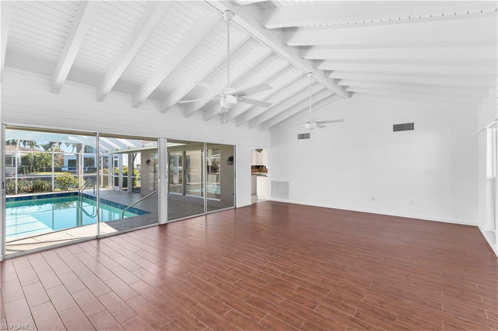 875 Robin Court Marco Island, FL 34145 - Photo 12 of 30 wooden floor in an empty room with a glass door