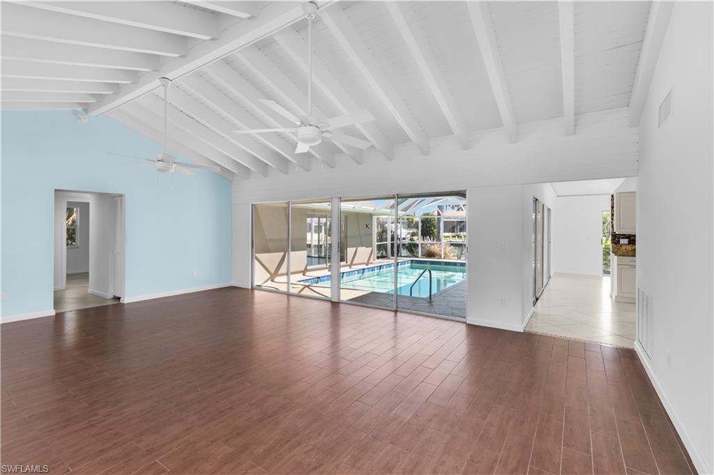 875 Robin Court Marco Island, FL 34145 - Photo 13 of 30 a view of an empty room with wooden floor