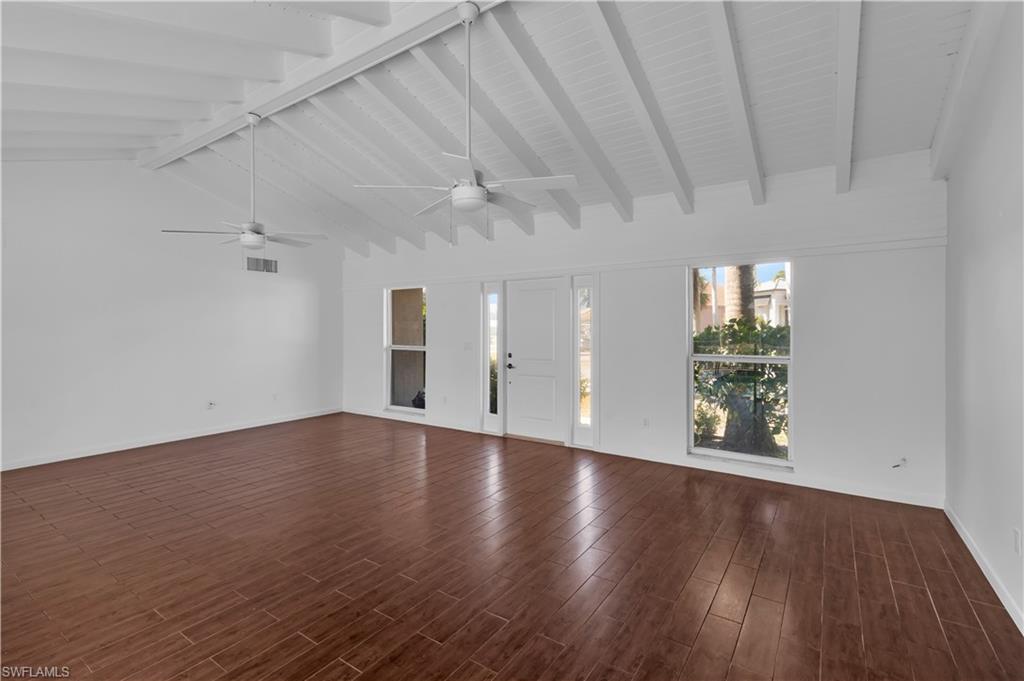 875 Robin Court Marco Island, FL 34145 - Photo 14 of 30 a view of an empty room with wooden floor and a window