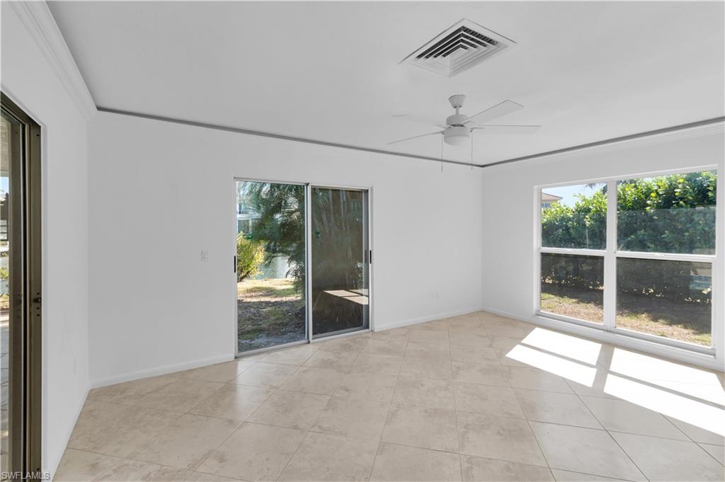 875 Robin Court Marco Island, FL 34145 - Photo 18 of 30 a view of an empty room with glass door