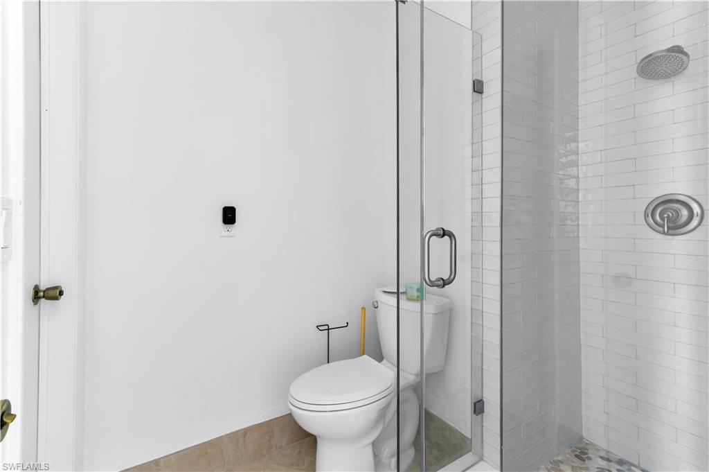 875 Robin Court Marco Island, FL 34145 - Photo 27 of 30 a bathroom with a toilet and a shower