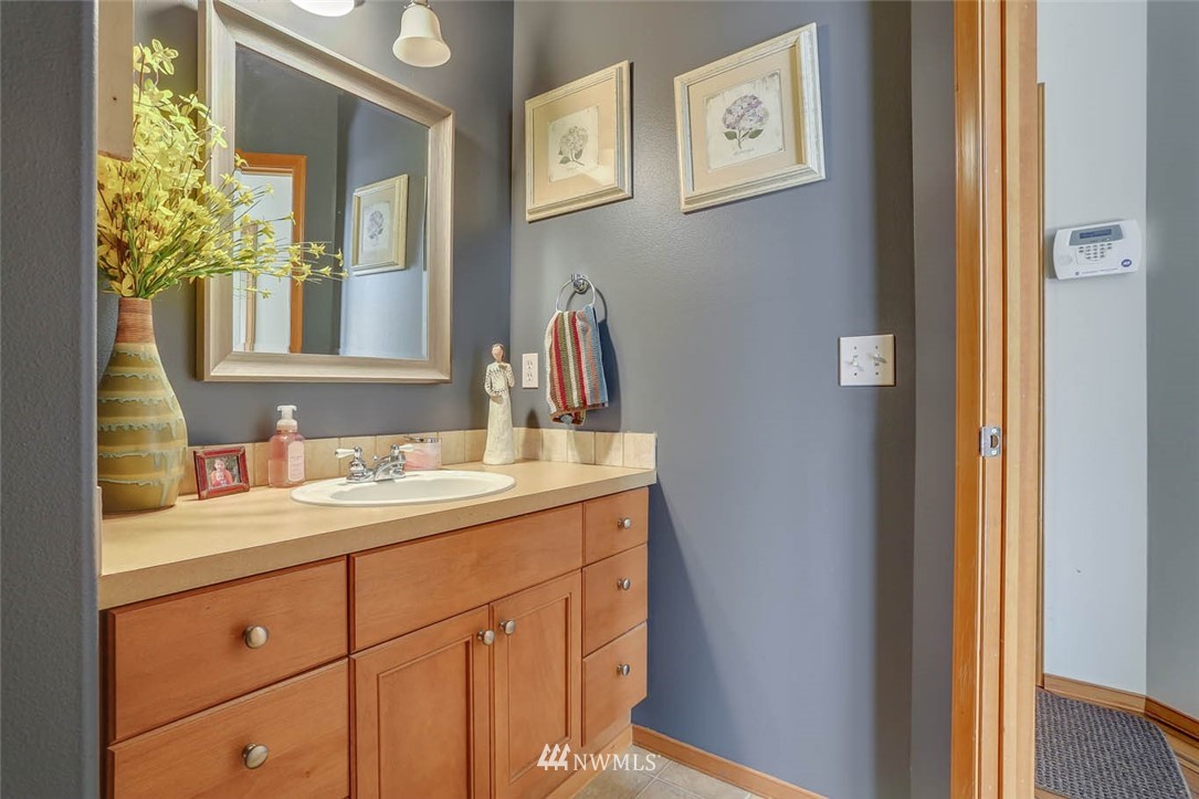 363 Pasco Drive Northeast Renton, WA 98059 - Photo 12 of 26 a bathroom with a granite countertop double vanity sink and a mirror