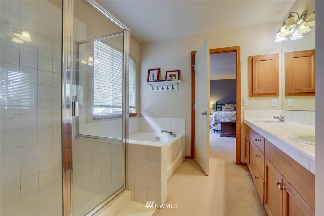 363 Pasco Drive Northeast Renton, WA 98059 - Photo 17 of 26 a spacious bathroom with a tub sink and mirror