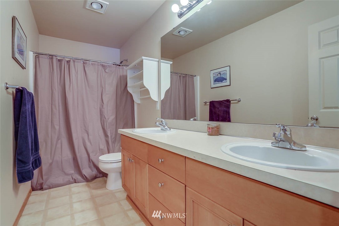 363 Pasco Drive Northeast Renton, WA 98059 - Photo 21 of 26 a bathroom with a granite countertop sink and a mirror