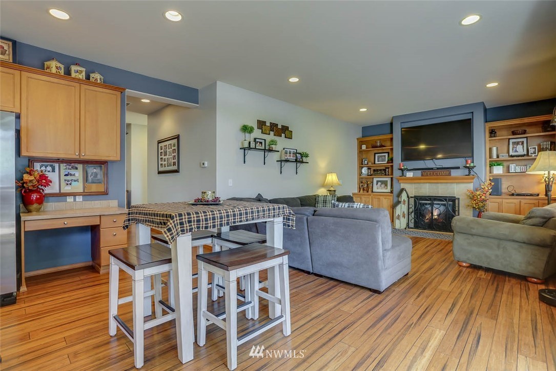 363 Pasco Drive Northeast Renton, WA 98059 - Photo 9 of 26 a living room with furniture a flat screen tv and a fireplace