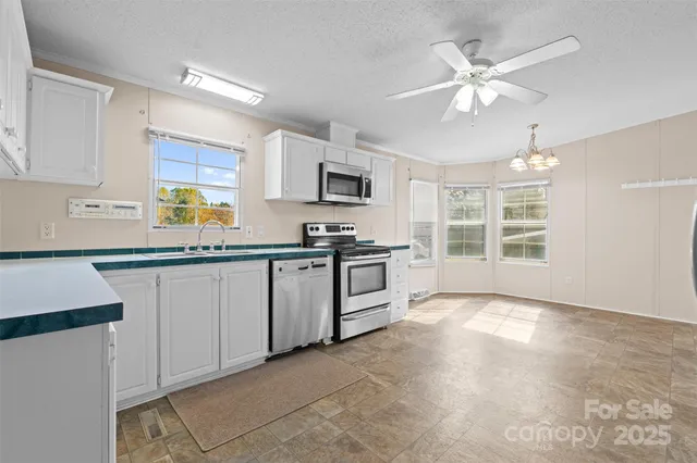 a view of a kitchen with an oven a kitchen view and a window