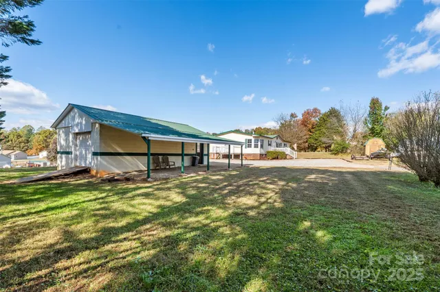 a backyard of a house with table and chairs