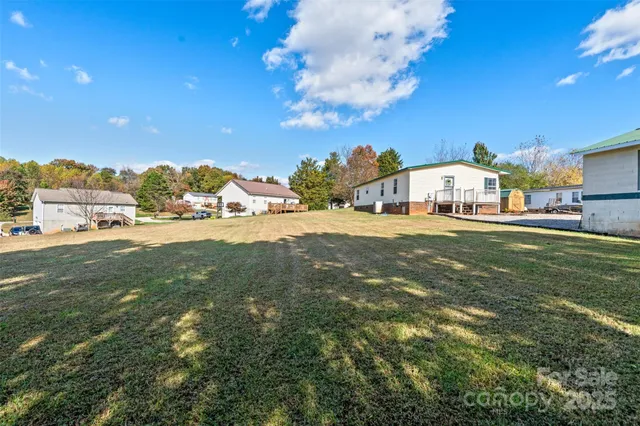 a view of a large pool with an outdoor space and seating area