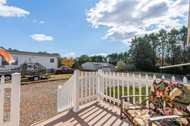 a view of residential houses with yard and car parked