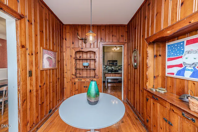 a bathroom with a granite countertop sink a toilet a mirror and shower