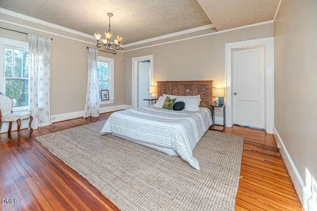 a view of a balcony with wooden floor and iron stairs
