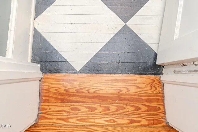 a view of a balcony with wooden floor and fence