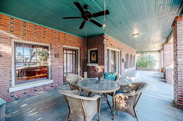 a view of a patio with a table and chairs and potted plants