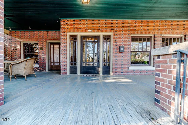 a living room with furniture large window and fireplace