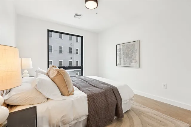 a bedroom with a bed and lamp