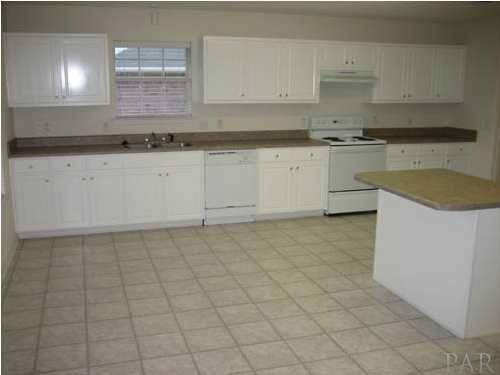 7045 Woodside Road Pensacola, FL 32526 - Photo 6 of 17 Cabinets and Counter Tops Galore in this kitchen provides a generous amount of storage and work space.
