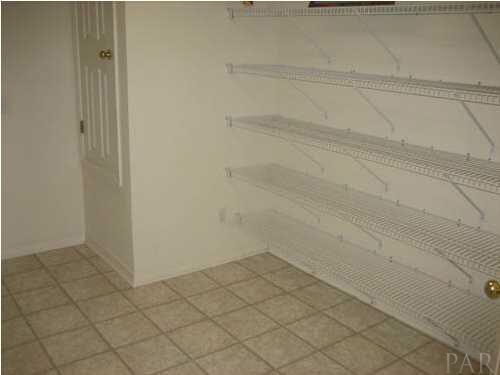 7045 Woodside Road Pensacola, FL 32526 - Photo 7 of 17 Large Walk-in Laundry Room with pantry shelves provides for abundance of storage.