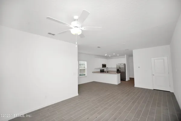 a view of a kitchen with wooden floor