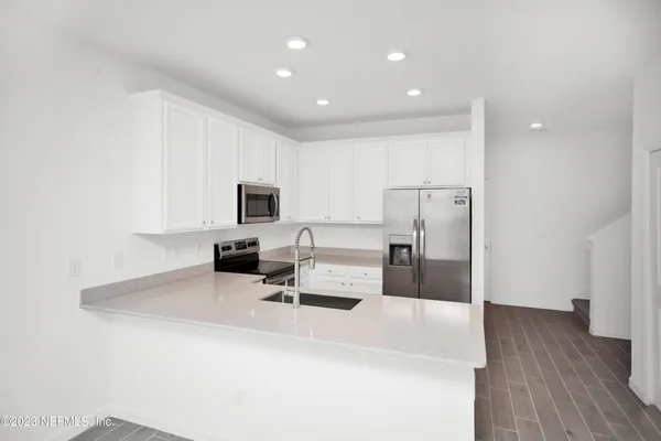 a kitchen with a sink and a mirror