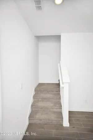 a view of staircase with white walls