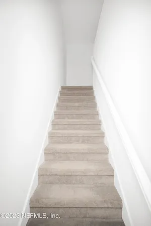 a view of a hallway with white walls
