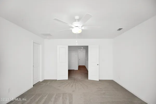 a view of a room with a ceiling fan