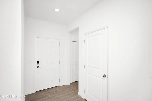 a view of a room with wooden floor