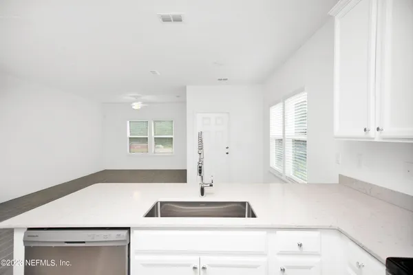 a kitchen with a sink and large window