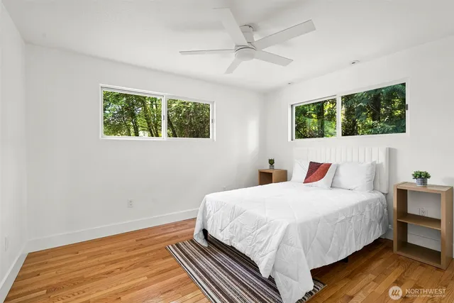a bedroom with a bed and large window