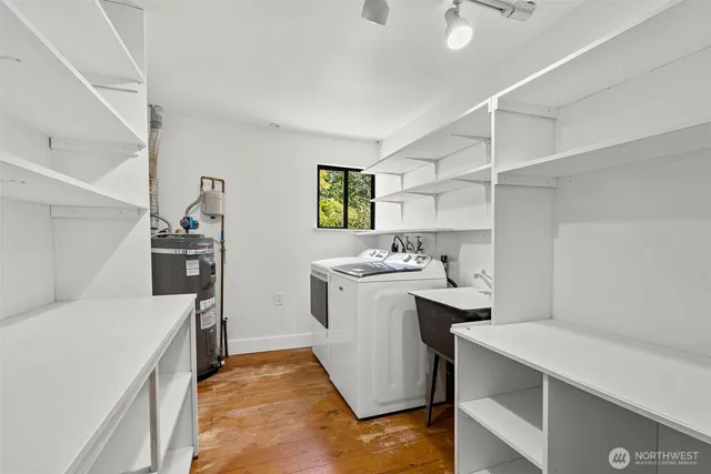 a room with a sink a washer and dryer
