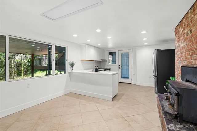 a large white kitchen with a large window