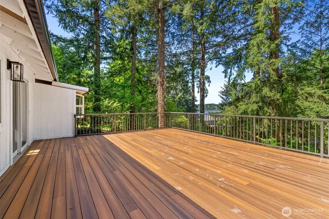 a view of backyard with wooden floor and fence