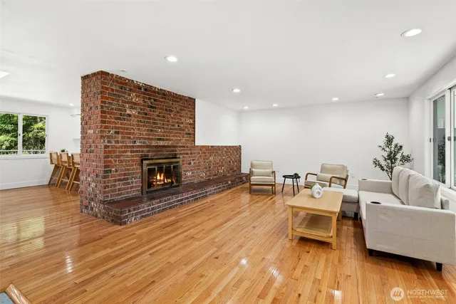a living room with furniture wooden floor and a fireplace